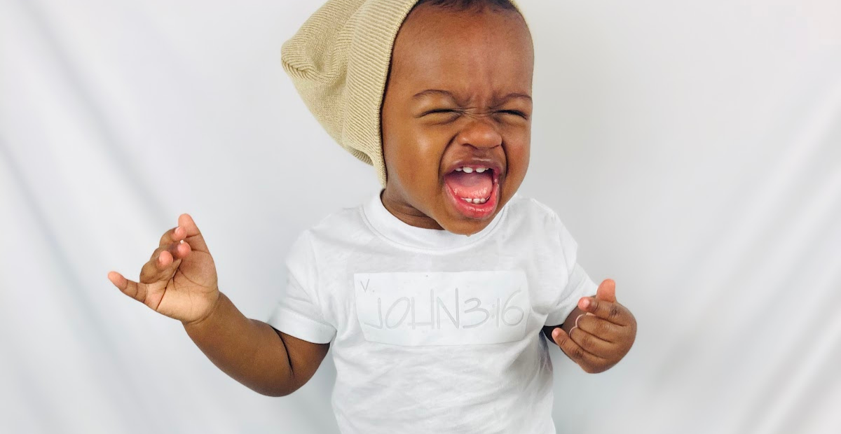 Toddler wearing a shirt and beanie on their head